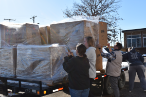 People unloading shipping pallets